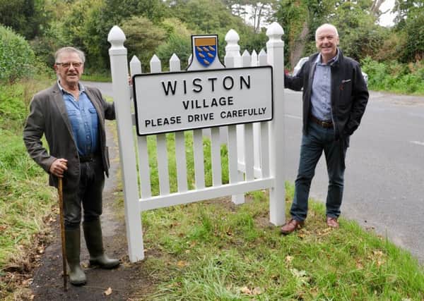 Wiston Parish Council chairman Sid Garner with vice chairman Ken Newton and the new village signs. Photo: Stephen Goodger SUS-180926-130423001