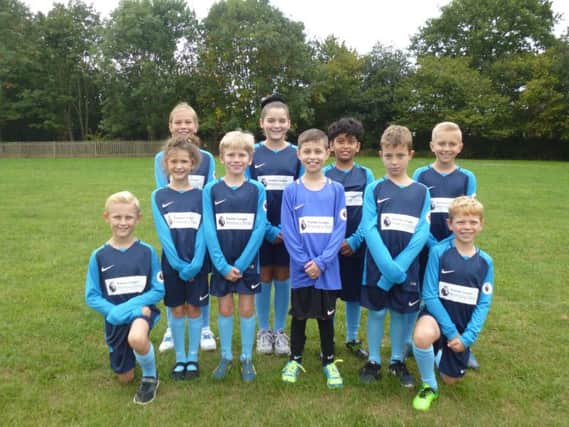 Pupils at Castlewood Primary receive their free football kit