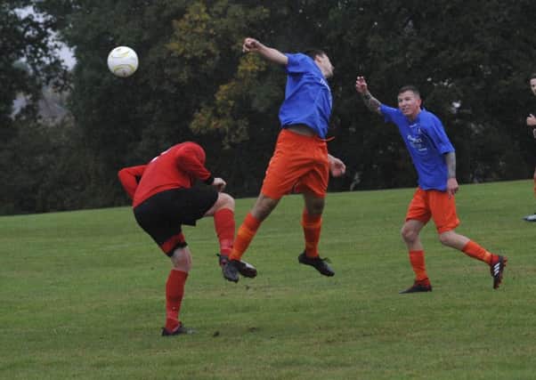 Bexhill AAC and Battle Baptists contest an aerial ball at Buxton Drive on Saturday. Pictures by Simon Newstead