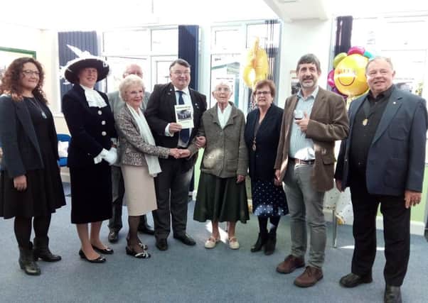 Sight Support Worthing president Bob Smytherman, centre, with the new book, Providing the Jam, and guests at the launch party