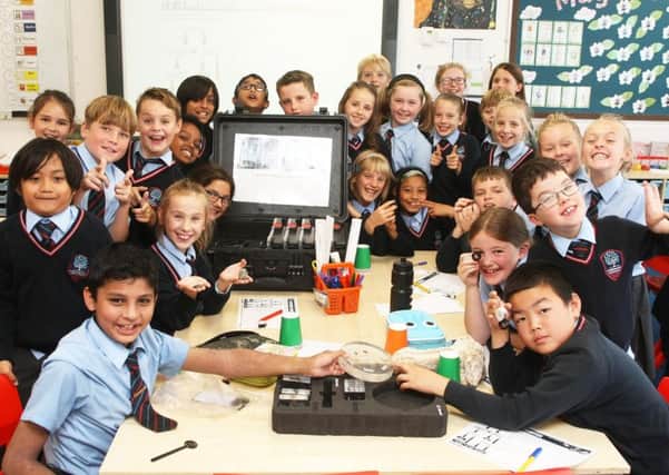 Excited year-five pupils with the lunar samples and meteorites at Chesswood Junior School, Worthing. Picture: Derek Martin DM1894142a