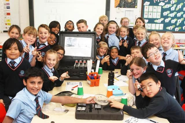 Excited year-five pupils with the lunar samples and meteorites at Chesswood Junior School, Worthing. Picture: Derek Martin DM1894142a