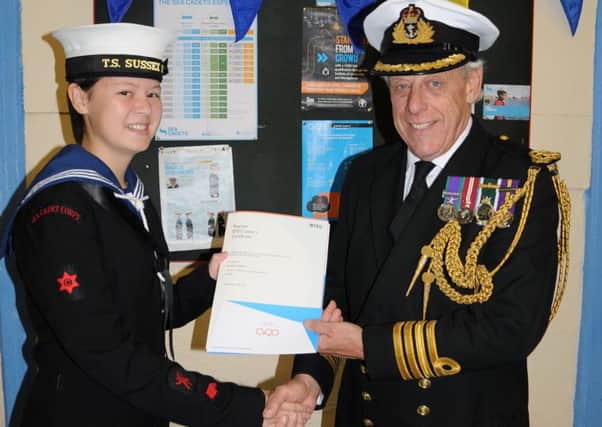 Captain John Stoy, president of Littlehampton Sea Cadet Unit, with ordinary cadet Shania Garbett and her BTEC Level 1 certificate
