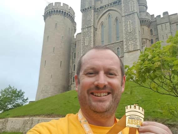 Myself with my medal and the iconic Bake House Tower behind