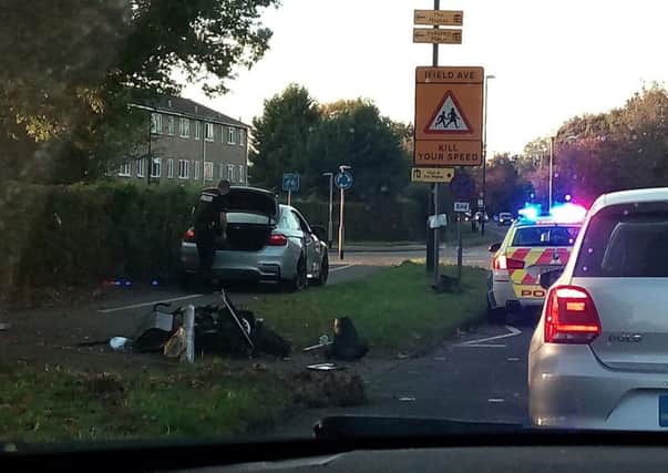 The damaged car and traffic light in Ifield Avenue, Crawley