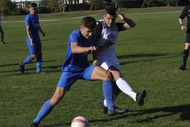 Jamie Bunn tussles for possession during the 3-3 draw at The Polegrove.