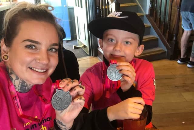 Natasha-Leigh Stewart and Alfie Hooper with their medals for completing the Walk of Hope