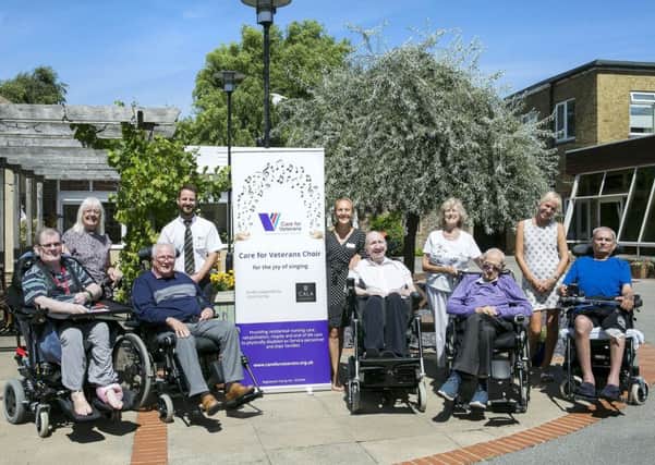 Andy Mair from CALA Homes (back row, second left) and Christine Gillott from Care for Veterans (back row, third right) with volunteers and choir members. Picture: David McHugh