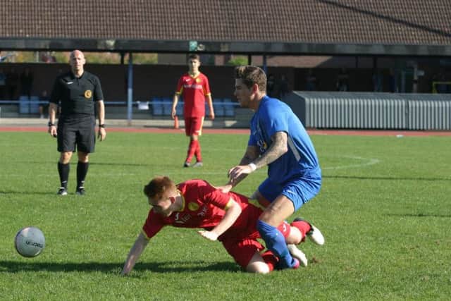Shaun Findlay (blue) in action for Broadbridge Heath. Photo by Clive Turner