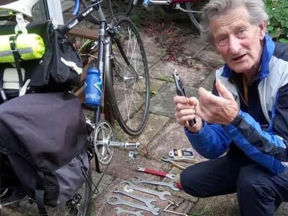 Bike repairman Keith Dodman fixing a bicycle.