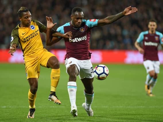 Jose Izquierdo battles Michail Antonio for the ball away to West Ham last season. Picture by PW Sporting Photography