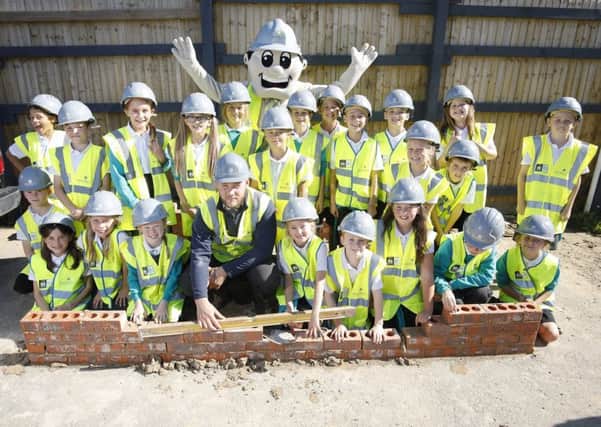 Pupils from St Peters C of E Primary School in Henfield at Barratt Homes Bishop Park development in the village during their site safety trip