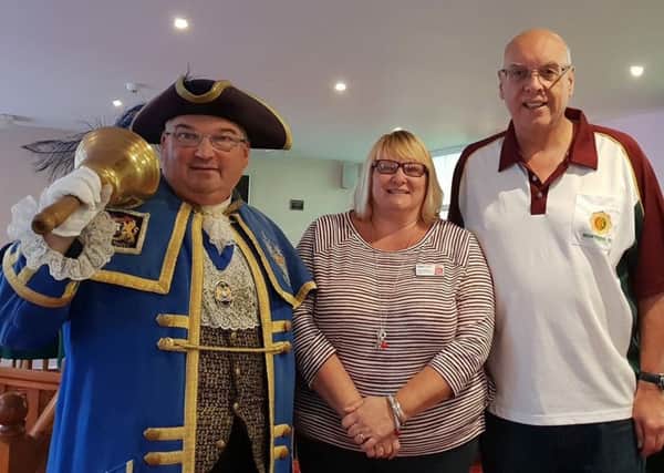 Worthing town crier Bob Smytherman with Guild Care community fundraiser Auds Stapleton and organiser Kevin Buck