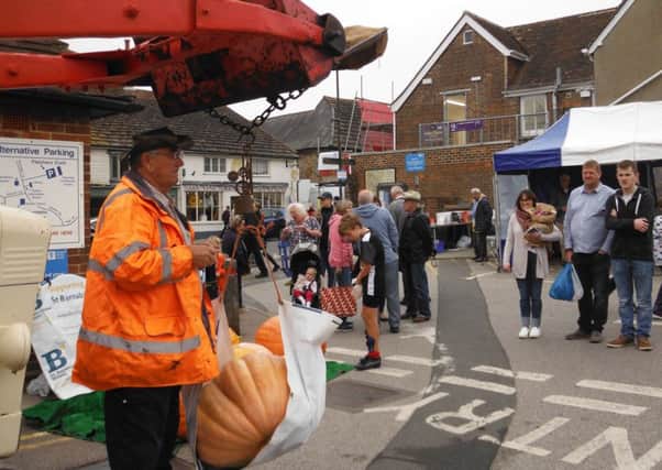 Weighing the pumpkins at Steyning Farmers Market on Saturday
