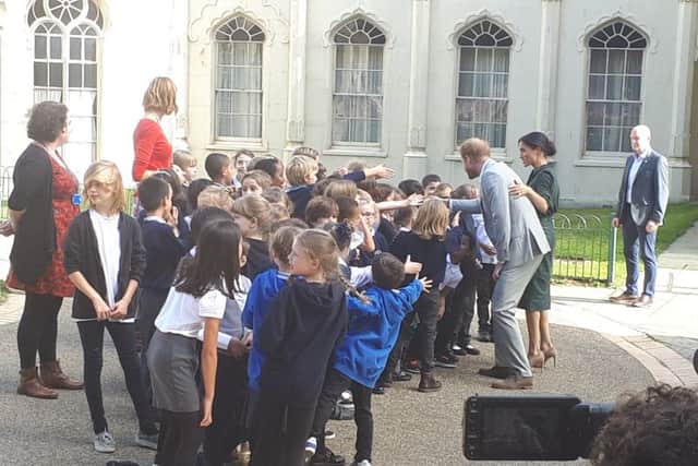 Harry and Meghan with children from Queen's Park School in Brighton
