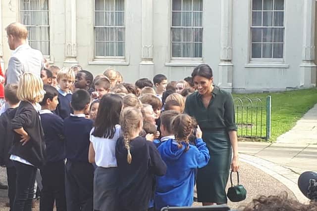 Harry and Meghan with children from Queen's Park School in Brighton SUS-180310-160516001