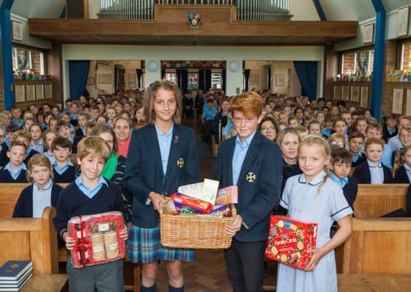 Cranleigh Prep School pupils with their harvest festival goodies during their service to celebrate the occasion SUS-180810-123052001