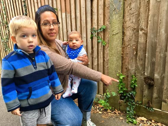 Leanne Balchin with her son Zachary, three, and Flynn, 17 weeks, in an alleyway off of Whiteways Close, Littlehampton, which has dog poo smeared on the fences.