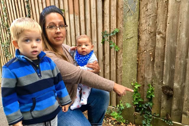 Leanne Balchin with her son Zachary, three, and Flynn, 17 weeks, in an alleyway off of Whiteways Close, Littlehampton, which has dog poo smeared on the fences.