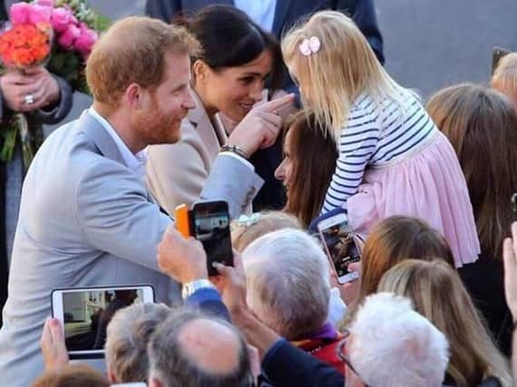 Freya Martin, 2, with Prince Harry and Meghan. Picture contributed