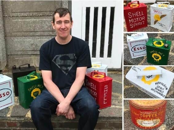 Ian Wood-Ellis with some of his restored Esso and Shell oil cans, as well as his next project, a Mackintosh Toffee biscuit tin
