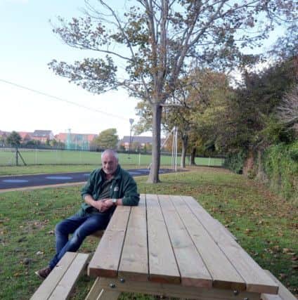Joe Colwell at one of his benches in West Park, Worthing