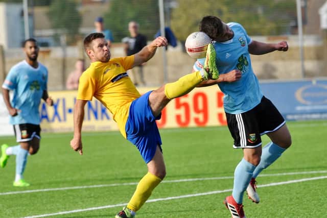 Lancing player-manager Mark Pulling battles for the ball. Picture by Stephen Goodger