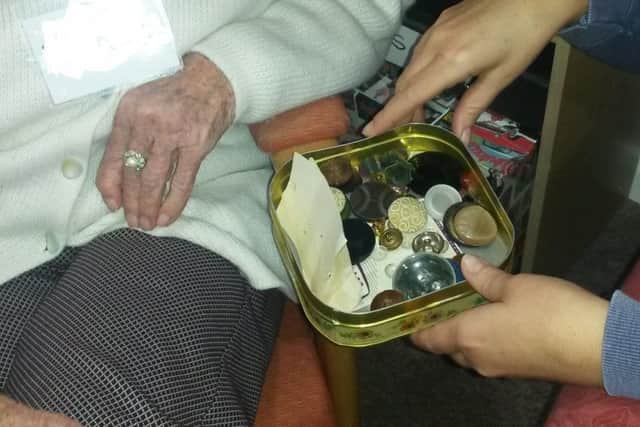 Using buttons in a tin to reflect on memories