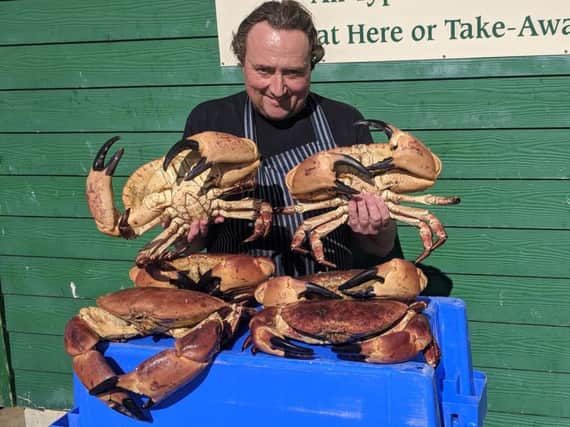 Simon Finch with the large crabs, including the monster specimen