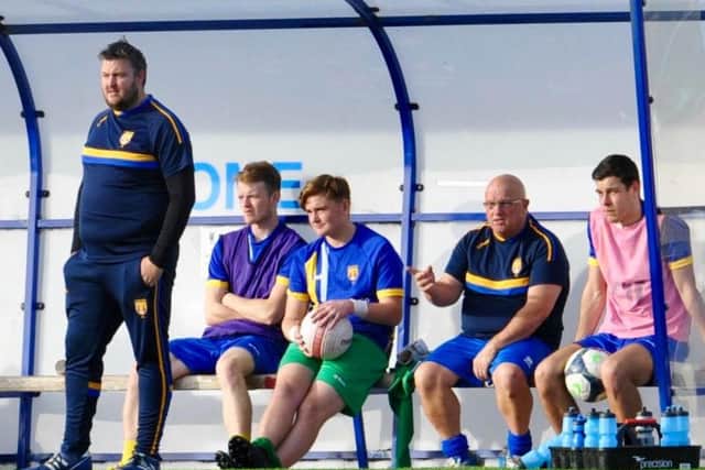 Lancing assistant coach Danny Woods (far left) in the dug-out yesterday. Picture by Stephen Goodger