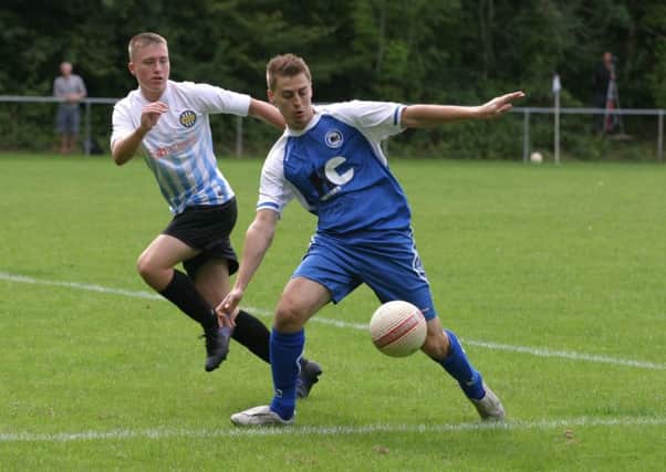 Patrick O`Sullivan (blue) scored twice for Roffey FC. Photo by Clive Turner