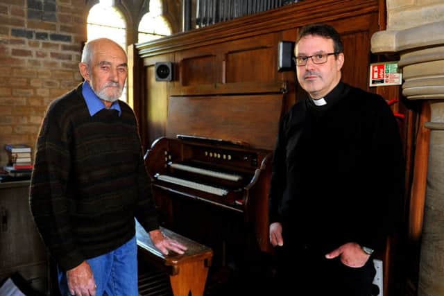 Churchwarden John Sired and Father Russell Stagg with the damaged organ