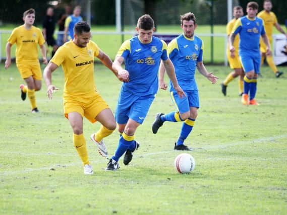 Rustington, in blue and in action earlier in the season against Upper Beeding, maintained their unbeaten start to the season with a 2-1 home win over Rottingdean Village on Saturday in Division 2. Picture by Derek Martin.