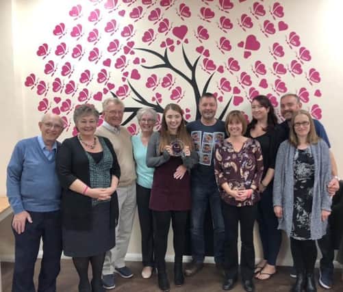 Hannah Richards, holding her Pride of Britain fundraising award, pictured with members of her family at You Raise Me Up, in Polegate. SUS-180910-162834001