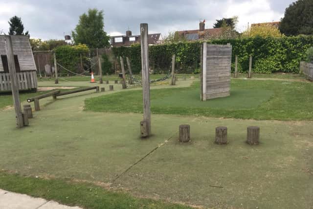 The surface around the play equipment was a mixture of carpet, grass and exposed earth and stone, all incredibly worn