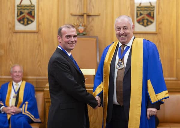 James Mellor (left) being sworn in by Master of the Guild Lee Robertson SUS-181016-112012001