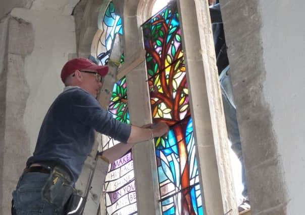 Working on the installation of the Peace Window at St Mary's Church in Yapton