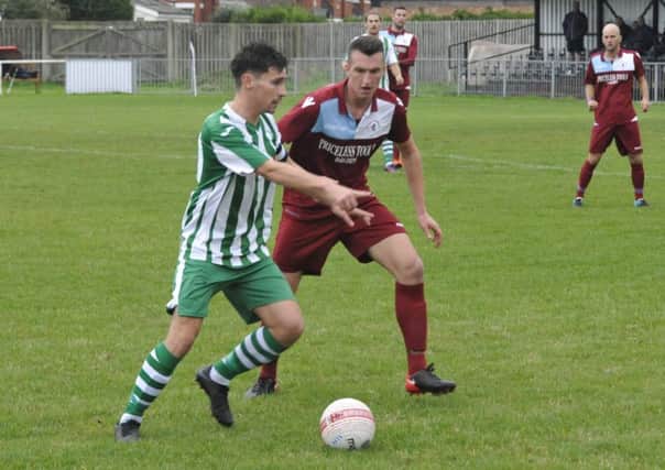 Little Common midfielder Liam Ward closes down a Chichester City opponent at The Oval last weekend. Picture by Simon Newstead