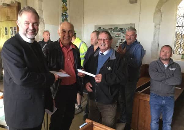 Rev Jonathan Swindells, Rector of St. James Church, is handed the completion certificate for St James' Centre by architect Richard Meynell and Trevor Couzens from T Couzens Builders.