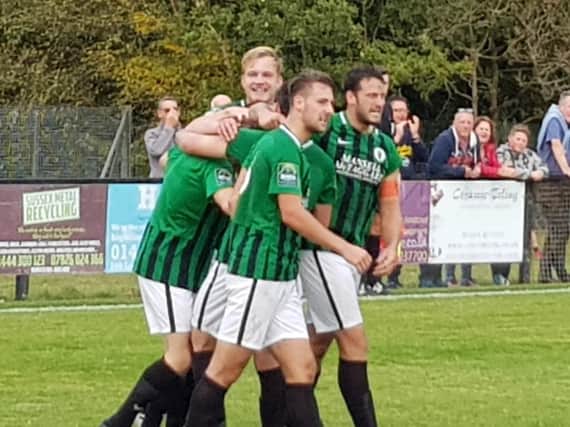 Burgess Hill players celebrate with goalscorer Pat Harding. Picture by Mark Sandell