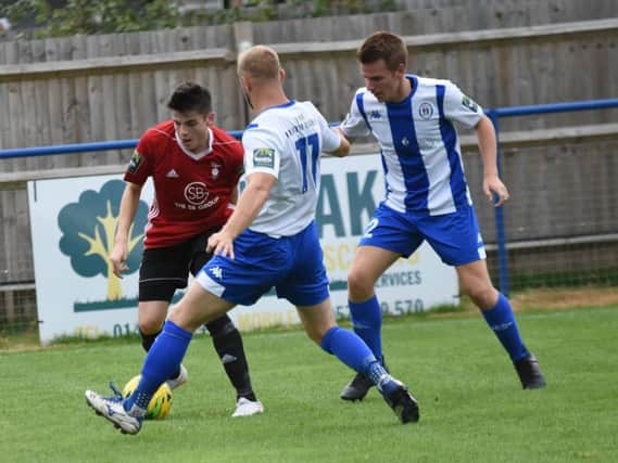Max Miller and Keiran Rowe double up against an attacker. Haywards Heath Town v Bracknell Town. Picture by Grahame Lehkyj