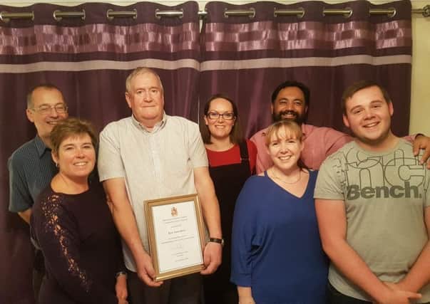 Ken Saunders, chairman of Dumbrills Close Residents Association in Burgess Hill, holding the award, with delighted members