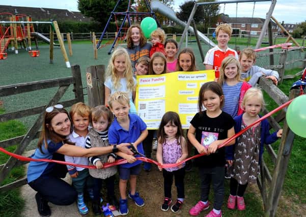 Children help to cut the ribbon to officially open the new playground in Horsted Keynes. Photo by Steve Robards