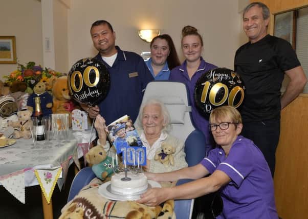 Florence Boulton known as Ronnie celebrates her 100th birthday with staff at Woodside Hall nursing home. Photograph by Jon Rigby (SUS-181015-114536008)