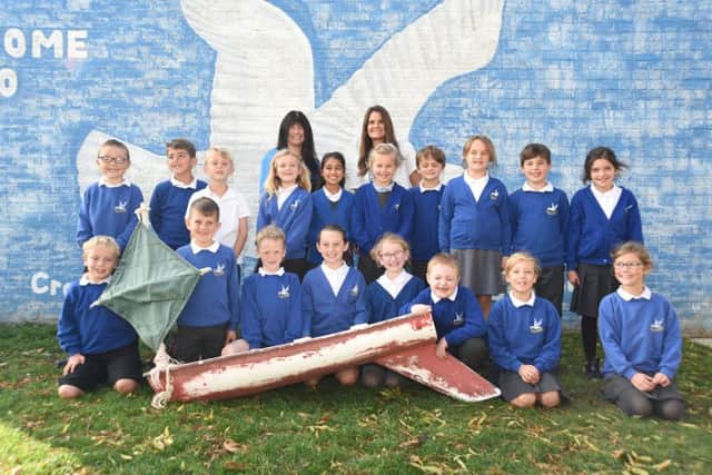 Andrea Keith, Head Teacher at Cradle Hill Community Primary School (back row left) and Nikki Hills (back row right) with Year Three pupils and the miniature boat