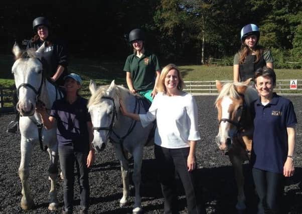 Amber is pictured with members and volunteer instructors of Riding for the Disabled Association at Fairlight Hall.