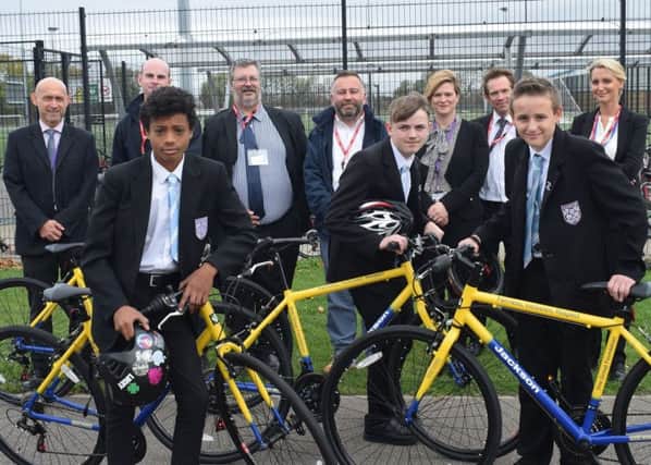 The presentation at Littlehampton Academy with, back row, school chaplain Paul Sanderson, Jackson regional engineer Callum Corbin, Jackson contracts manager Richard Killean, Jackson site agent Rod Heath, academy vice-principal Bianca Greenhaigh, West Sussex Highways representatives Alex Sharkey and Elaine Martin, and, front, three of the five students who have received the bicycles