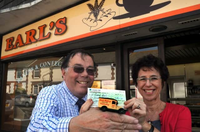 Stuart Earl presenting money to St Michael's Hospice in 2011 after commissioning a model of a Vintage Earl's Bread Van.
Stuart is pictured with Marcia Dart, from the Hospice, at Earl's Bakery, Little Common.