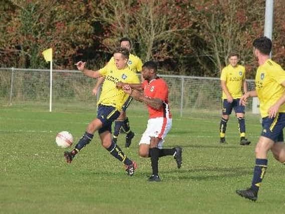 Joe Manners tries to get Sidlesham moving against Chatham in the FA Vase / Picture by Kate Shemilt