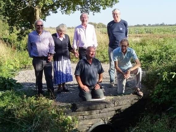 Community volunteers at one element of the completed works in Almodington. From left, Keith Martin, Veronica Wilks, Andries Devaal, John Stant. Front: Campbell Thorpe, Robert Carey. Picture by J. M. Bowering